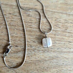 Sterling silver pendant with wrapped pearl.